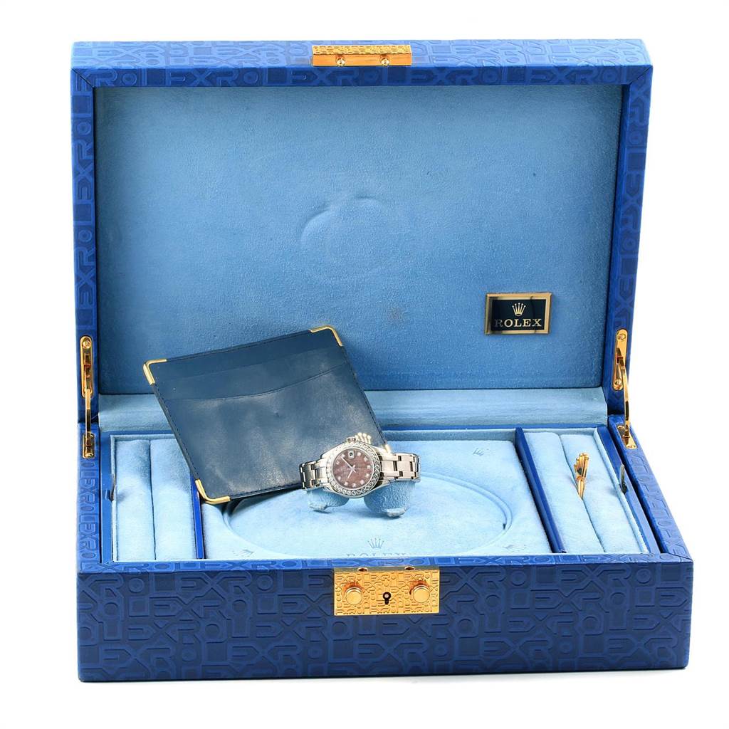 The image shows a Rolex Pearlmaster 80299 Women
s White Gold Mother of Pearl Dial 80299 Women
s White Gold Mother of Pearl Dial watch inside an open blue watch box with gold embellishments.