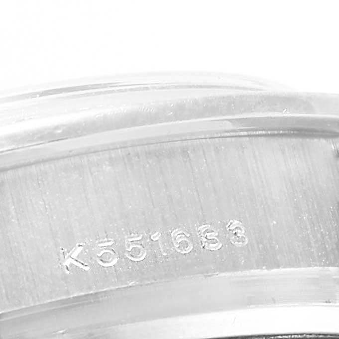 The image shows a close-up of the engraved serial number on the case of a Rolex Pearlmaster 80299 Women's White Gold Mother of Pearl Dial 80299 Women's White Gold Mother of Pearl Dial watch.