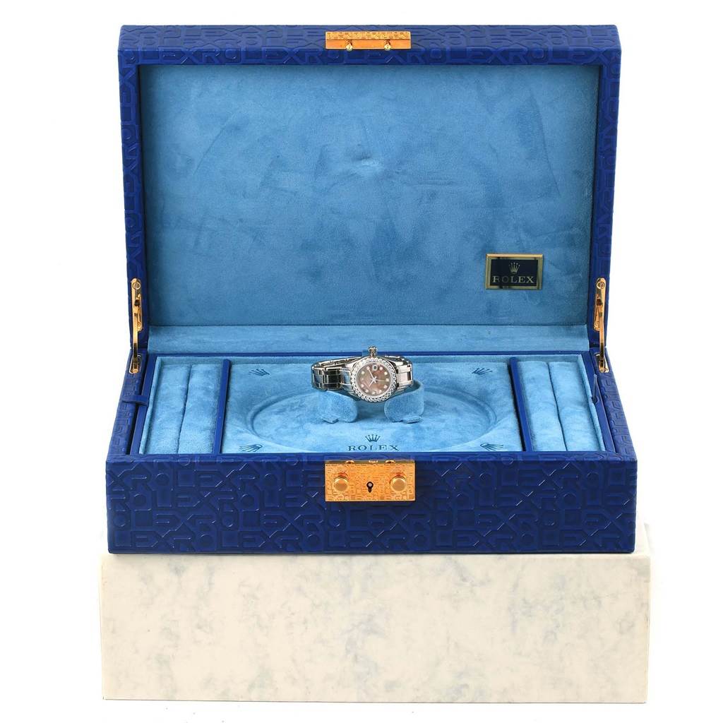 The Rolex Pearlmaster 80299 Women's White Gold Mother of Pearl Dial 80299 Women's White Gold Mother of Pearl Dial watch is displayed front-facing inside a blue luxury case.
