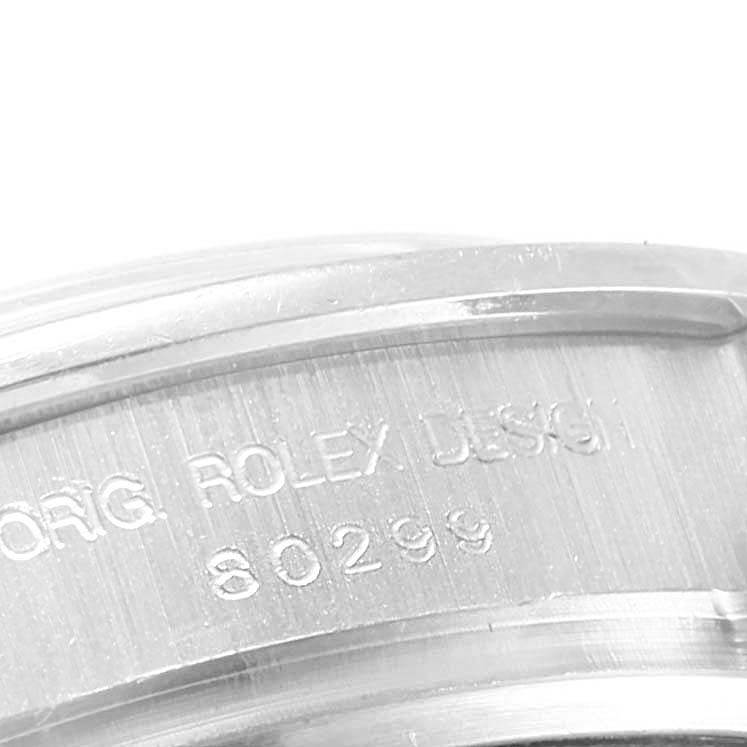 This close-up image shows the engraved part of the bezel or case back of a Rolex Pearlmaster 80299 Women's White Gold Mother of Pearl Dial 80299 Women's White Gold Mother of Pearl Dial watch.