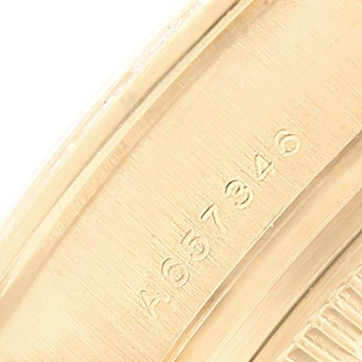 This close-up image shows the serial number engraving on the side of a Rolex Pearlmaster 80308 Women's Yellow Gold Mother of Pearl Dial 80308 Women's Yellow Gold Mother of Pearl Dial watch.