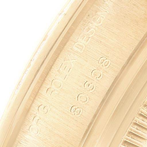The image shows an extreme close-up of the Rolex Pearlmaster 80308 Women's Yellow Gold Mother of Pearl Dial 80308 Women's Yellow Gold Mother of Pearl Dial's inner case, featuring engraved text.