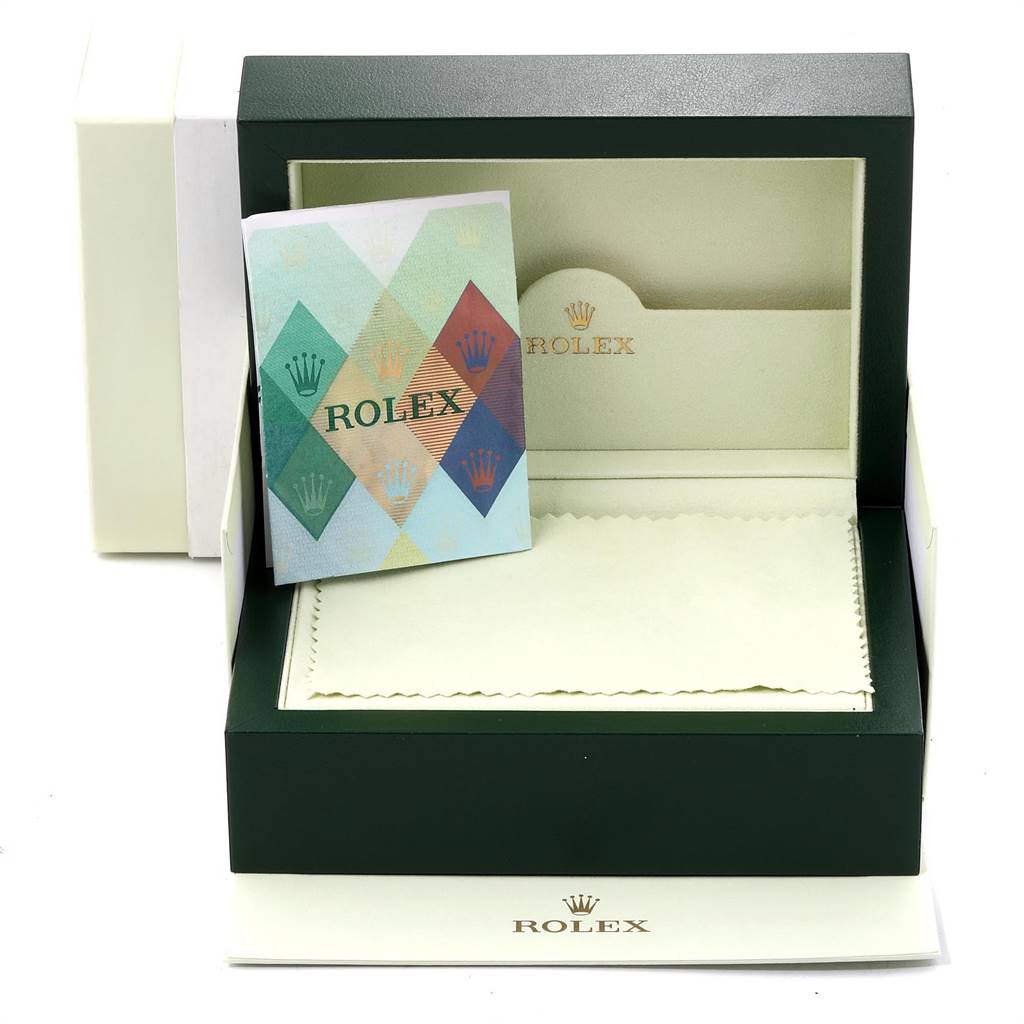 The image shows an open Rolex Pearlmaster 80299 Women's White Gold Mother of Pearl Dial 80299 Women's White Gold Mother of Pearl Dial watch box containing a booklet and a watch cleaning cloth.