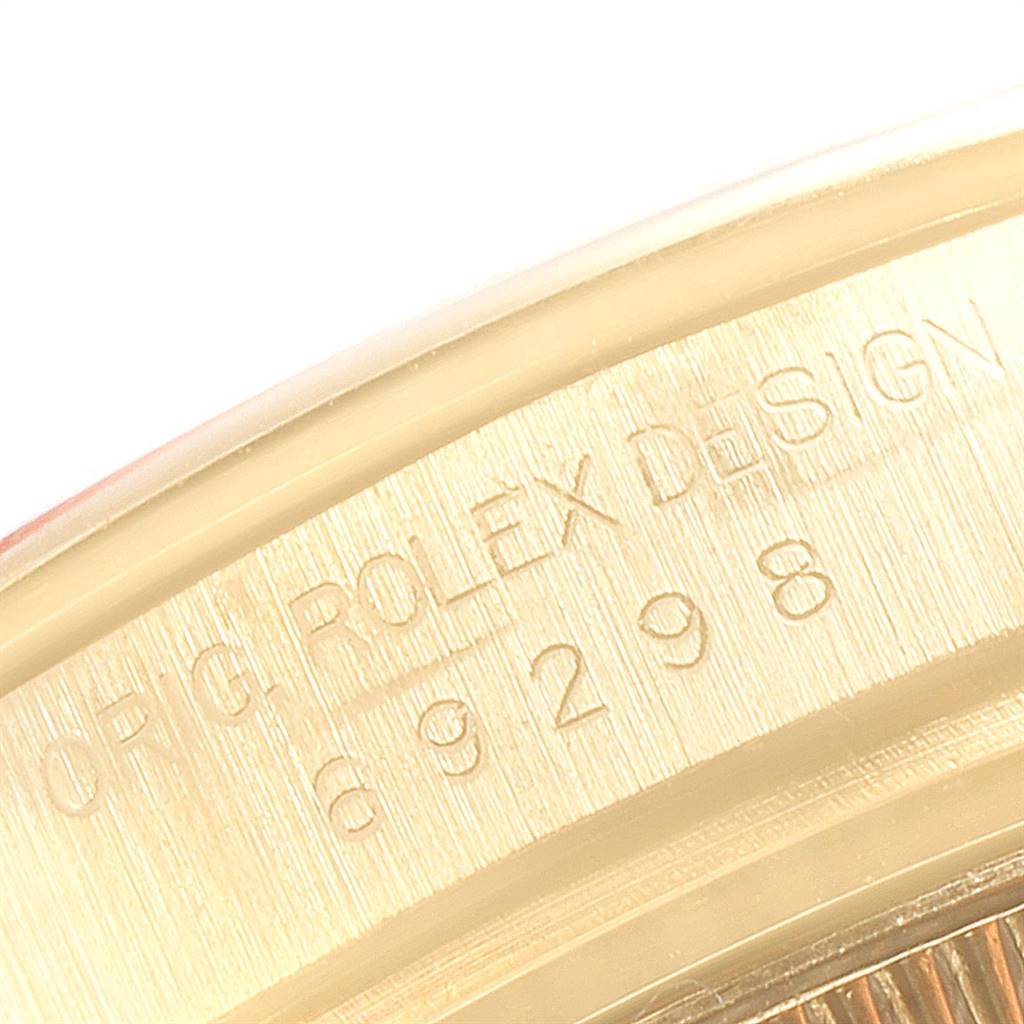 The image shows a close-up of the case back edge of a Rolex Pearlmaster 69298 Women's Yellow Gold Blue Dial 69298 Women's Yellow Gold Blue Dial watch, highlighting the engraved text and serial number.