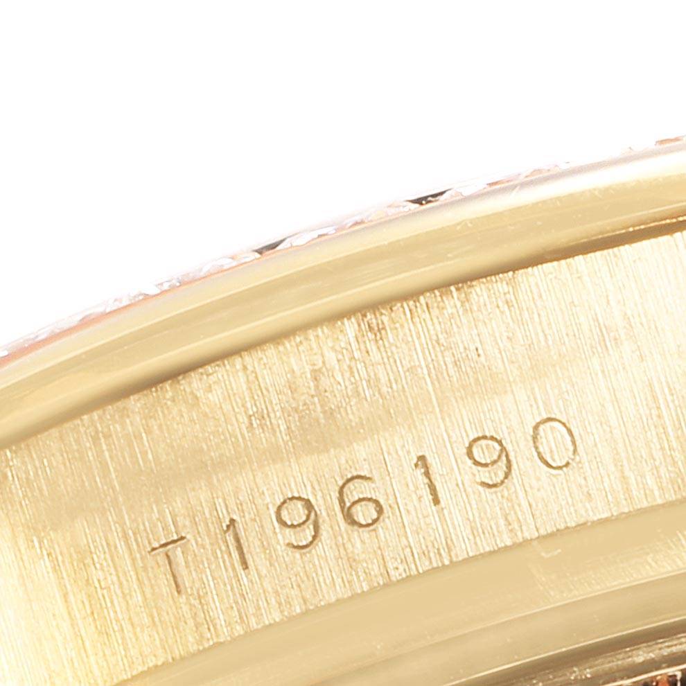 This image shows a close-up of the engraved serial number on the gold caseback rim of a Rolex Pearlmaster 69298 Women's Yellow Gold Blue Dial 69298 Women's Yellow Gold Blue Dial watch.