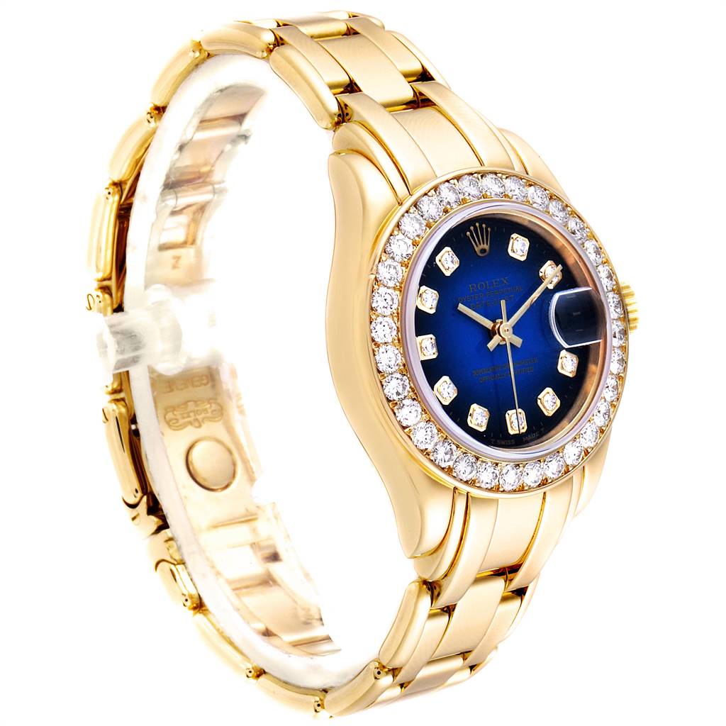 This is an angled view of the Rolex Pearlmaster 69298 Women's Yellow Gold Blue Dial 69298 Women's Yellow Gold Blue Dial watch showing the face, bezel with diamonds, and part of the gold bracelet.