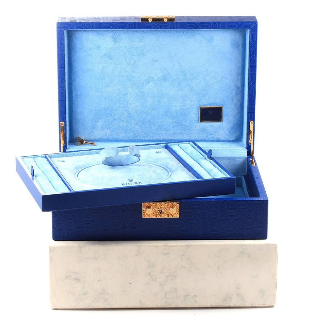 The image shows a blue Rolex Pearlmaster 69298 Women's Yellow Gold Champagne Dial 69298 Women's Yellow Gold Champagne Dial watch box and its accessories, including a key, with the lid open.