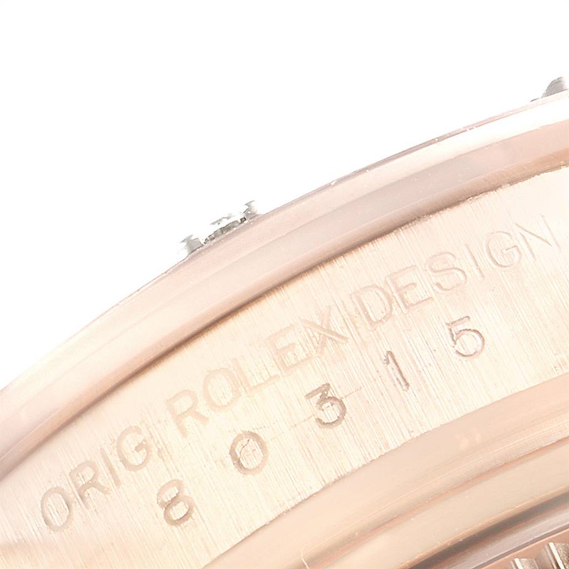 The image shows a close-up of the edge and engraved serial number of a Rolex Pearlmaster watch.