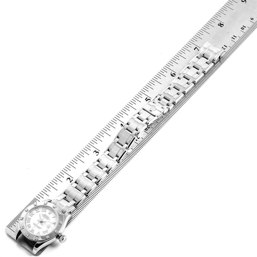The image shows a Rolex Pearlmaster 80319 Women's White Gold White Dial 80319 Women's White Gold White Dial watch laid flat alongside a ruler, displaying the watch dial and bracelet links.