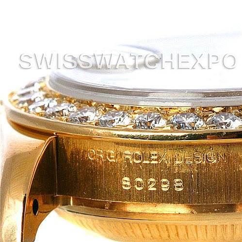 The image shows a close-up side view of a Rolex Pearlmaster 802998 Women's Yellow Gold Mother of Pearl Dial 802998 Women's Yellow Gold Mother of Pearl Dial watch, highlighting the bezel adorned with diamonds and part of the casing with inscriptions.