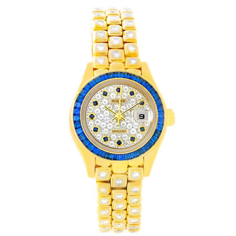 The image shows a Rolex Pearlmaster 69308 Women's Yellow Gold  69308 Women's Yellow Gold  watch from a front angle, highlighting its gold band, diamond-encrusted dial, and blue bezel.