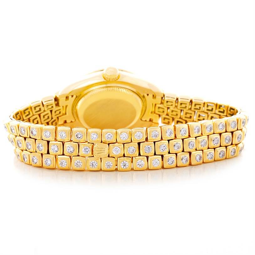 The image shows the back and bracelet of a Rolex Pearlmaster 69308 Women's Yellow Gold  69308 Women's Yellow Gold  watch, highlighting its gold and diamond embellishments.