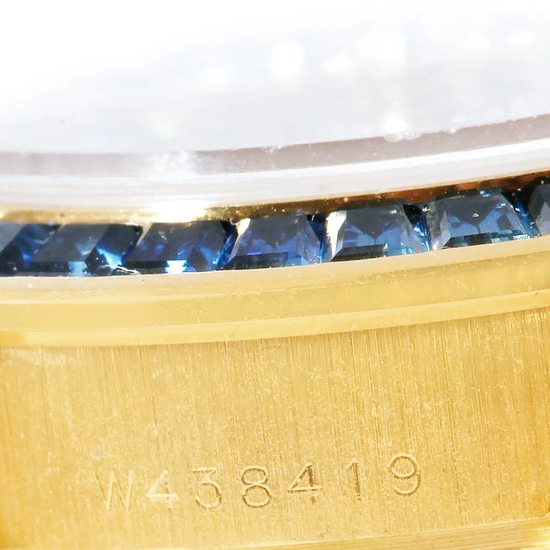 This close-up shows the serial number and gemstone detailing on the bezel of a Rolex Pearlmaster 69308 Women's Yellow Gold  69308 Women's Yellow Gold  watch.